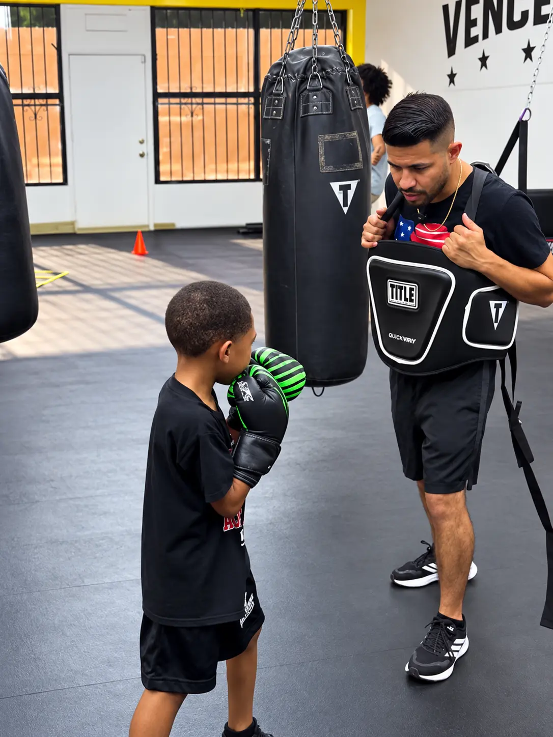 Coach training a young boxer